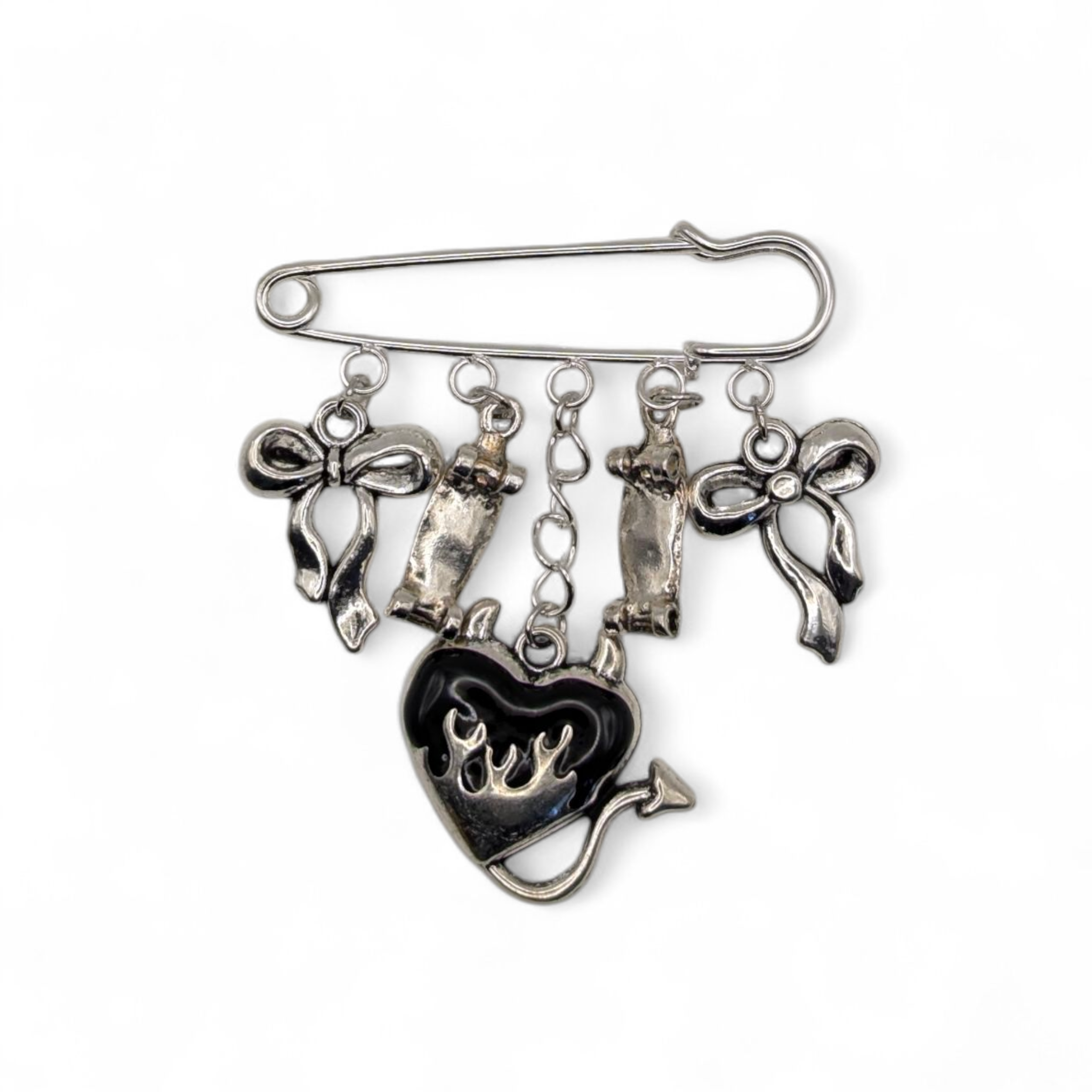 Silver brooch with heart-shaped charm and dangling elements on a white background